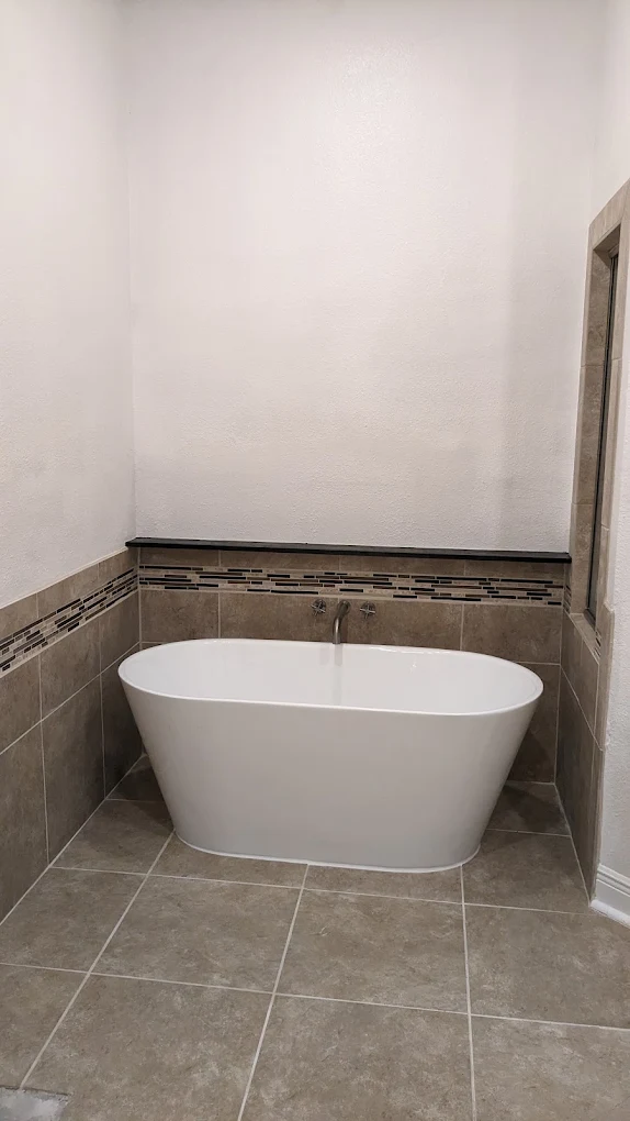 Luxury Bathroom with Freestanding Tub by First Shot Construction Orange TX